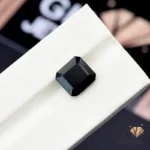 Square-cut 5.55-carat black tourmaline gemstone on a white display stand