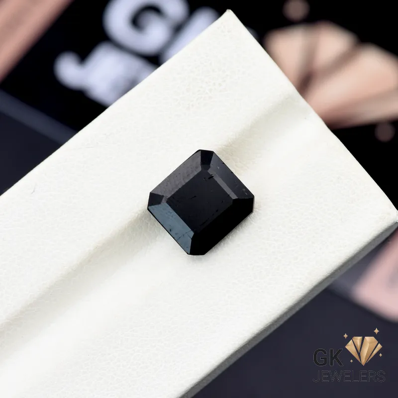 Square-cut 5.55-carat black tourmaline gemstone on a white display stand