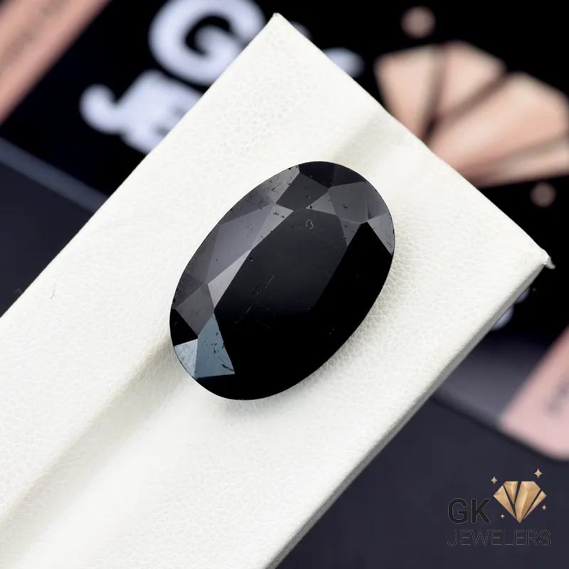 Oval-cut 20.80ct black tourmaline gemstone on white display stand