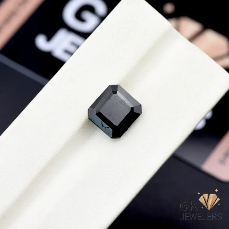 Square-cut 6.45-carat black tourmaline gemstone on white display, Afghanistan origin