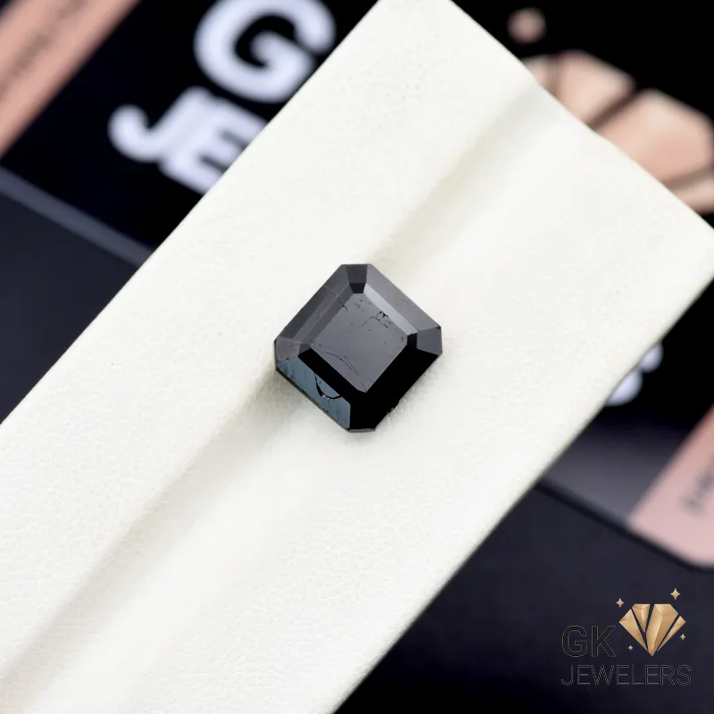 Square-cut 6.45-carat black tourmaline gemstone on white display, Afghanistan origin