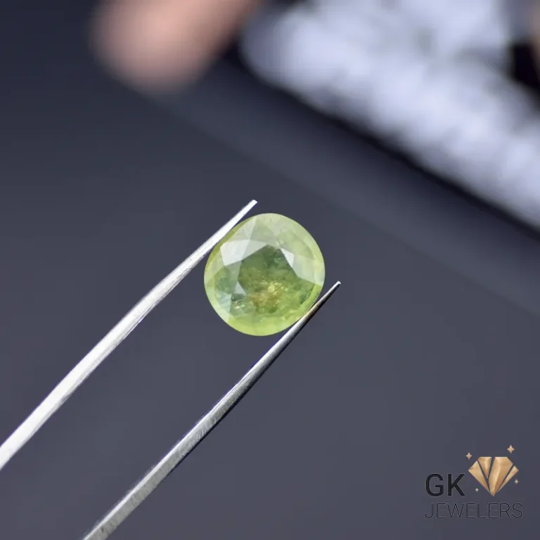 5.12-carat yellow sapphire gemstone held by metal tweezers on dark background