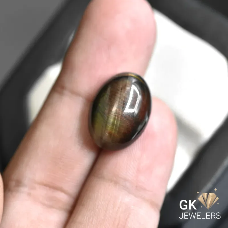 natural tiger eye 14.90ct black oval stone, GK Jewelers Pakistan authentic gemstone photo